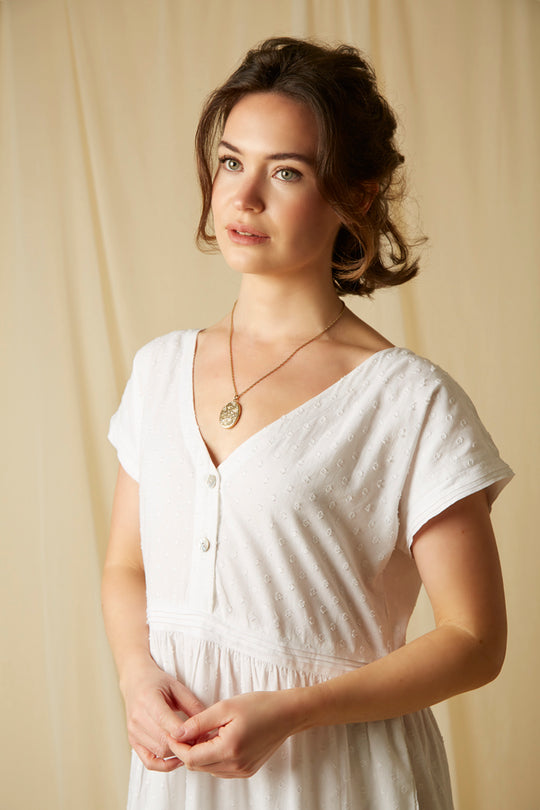 A beautiful white cotton nightdress with mother of pearl button up fastening, capped sleeves, pockets and cotton linen pleated details. A great nightie for night or day!